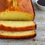 a loaf of white chocolate pound cake cut into a few slices