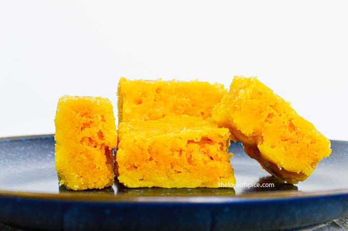 4 pieces of mysore pak on a blue plate