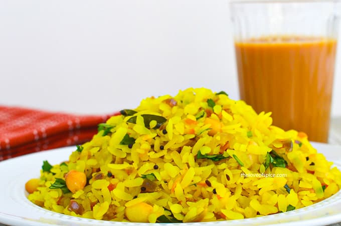 a plate kanda poha with adrak chai