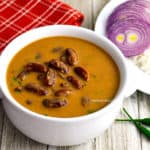 bowl of rajma with a plate of rice on the side