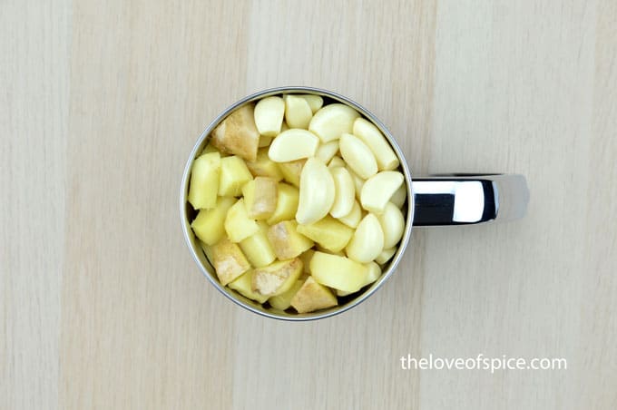 ginger cubes and garlic cloves in a mixer jar