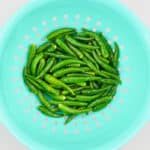 washed green chillies in a strainer