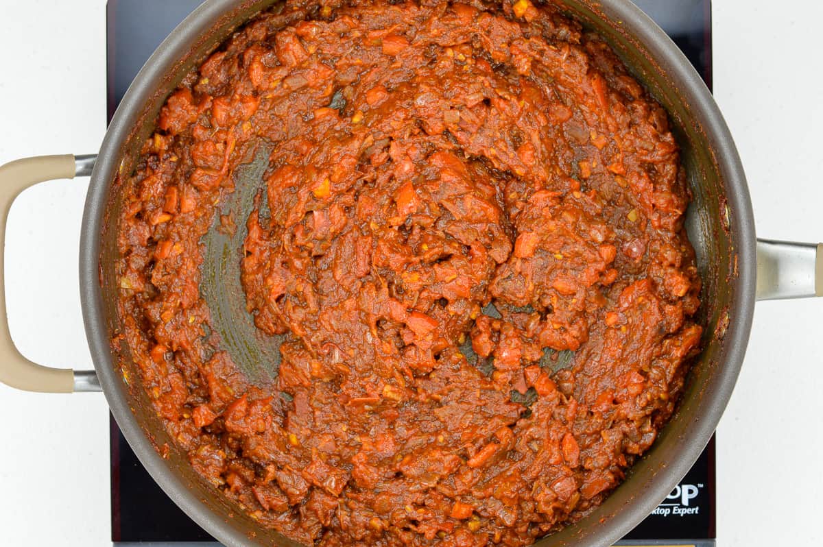 top shot of bhuna masala curry sauce base in a wide bottomed pan on the stovetop