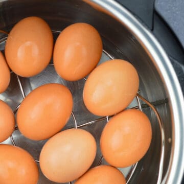 top close up shot of large brown eggs placed on a trivet in the instant pot