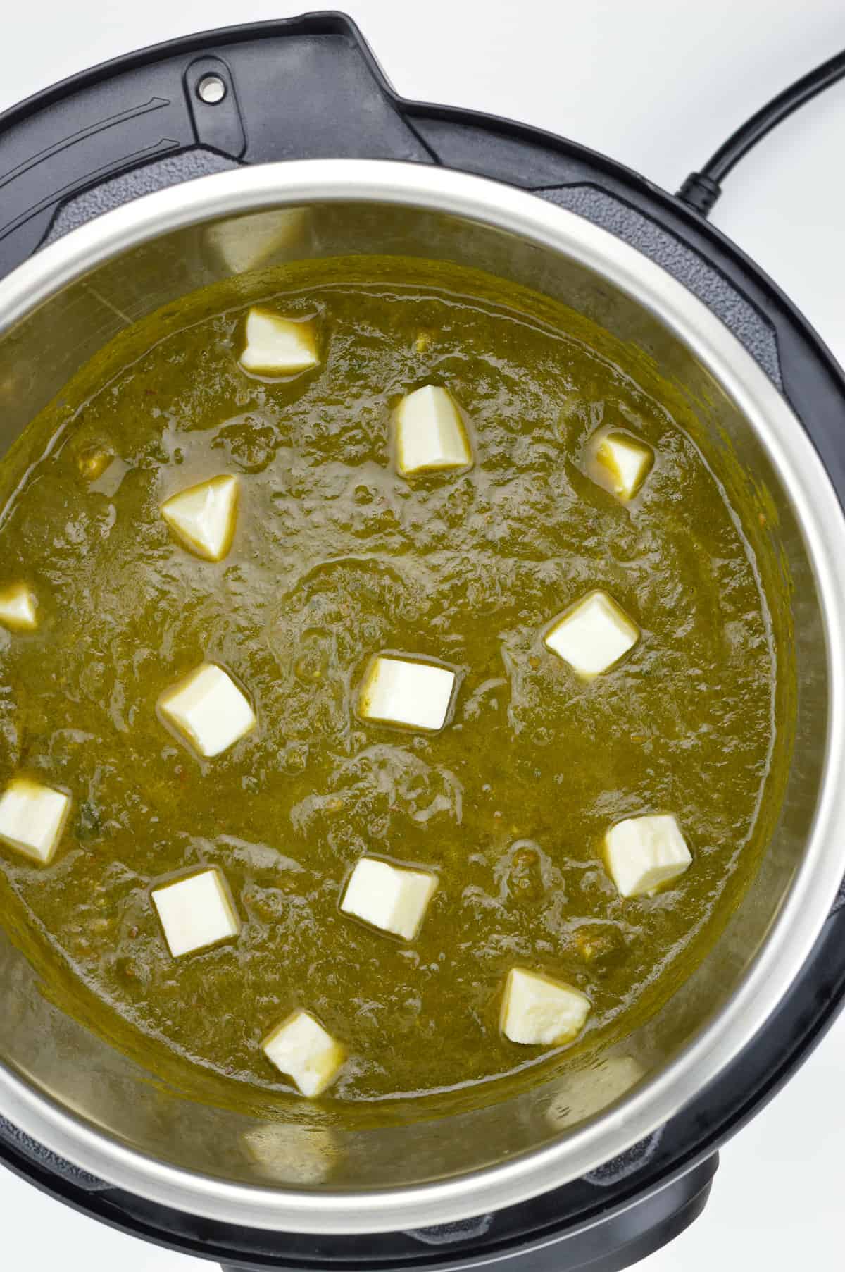 a top-down close-up shot of palak paneer in instant pot