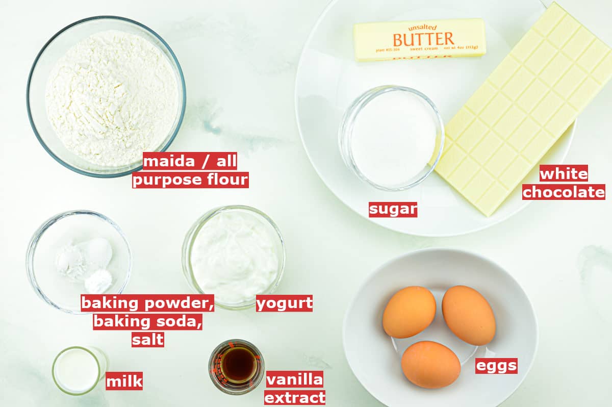 top shot of all the ingredients to make white chocolate pound cake, along with ingredient labels