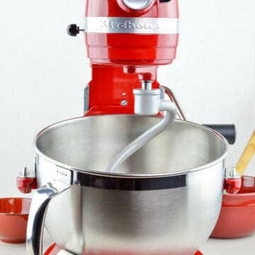 a close up shot of red colored 6 quart KitchenAid Professional stand mixer