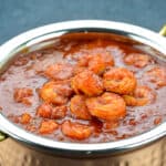 a close up shot of a serving kadai full of mangalorean prawns curry