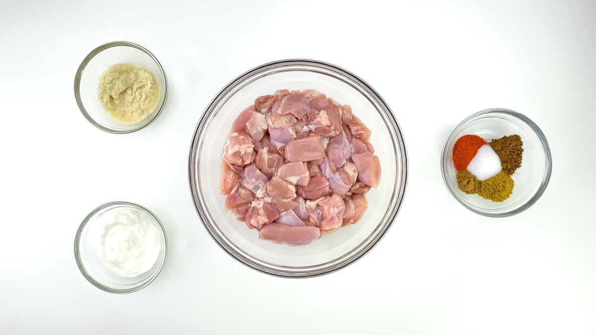 top shot of the ingredients required to marinate chicken to make chicken biryani