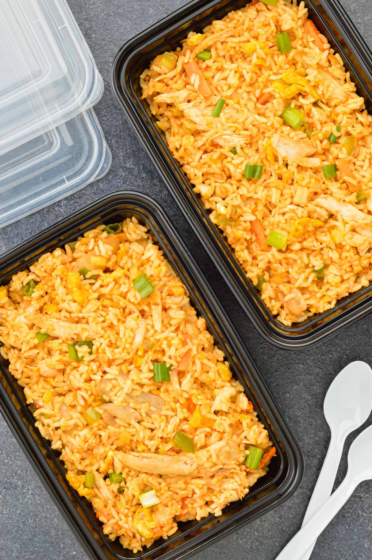 close up top shot of 2 meal prep lunch boxes full of chicken fried rice.