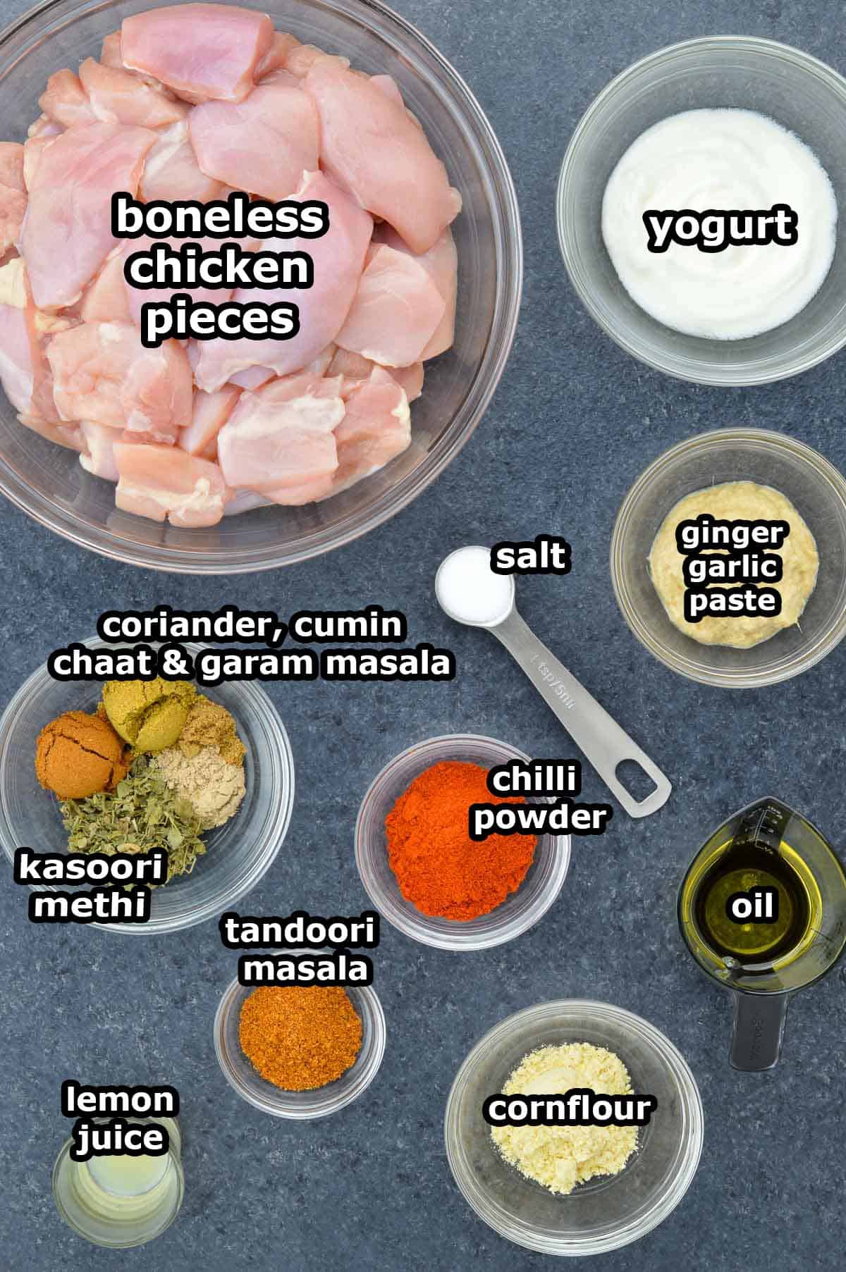 top shot of all the ingredients required to make boneless tandoori chicken bites in air fryer, shared along with ingredient labels.