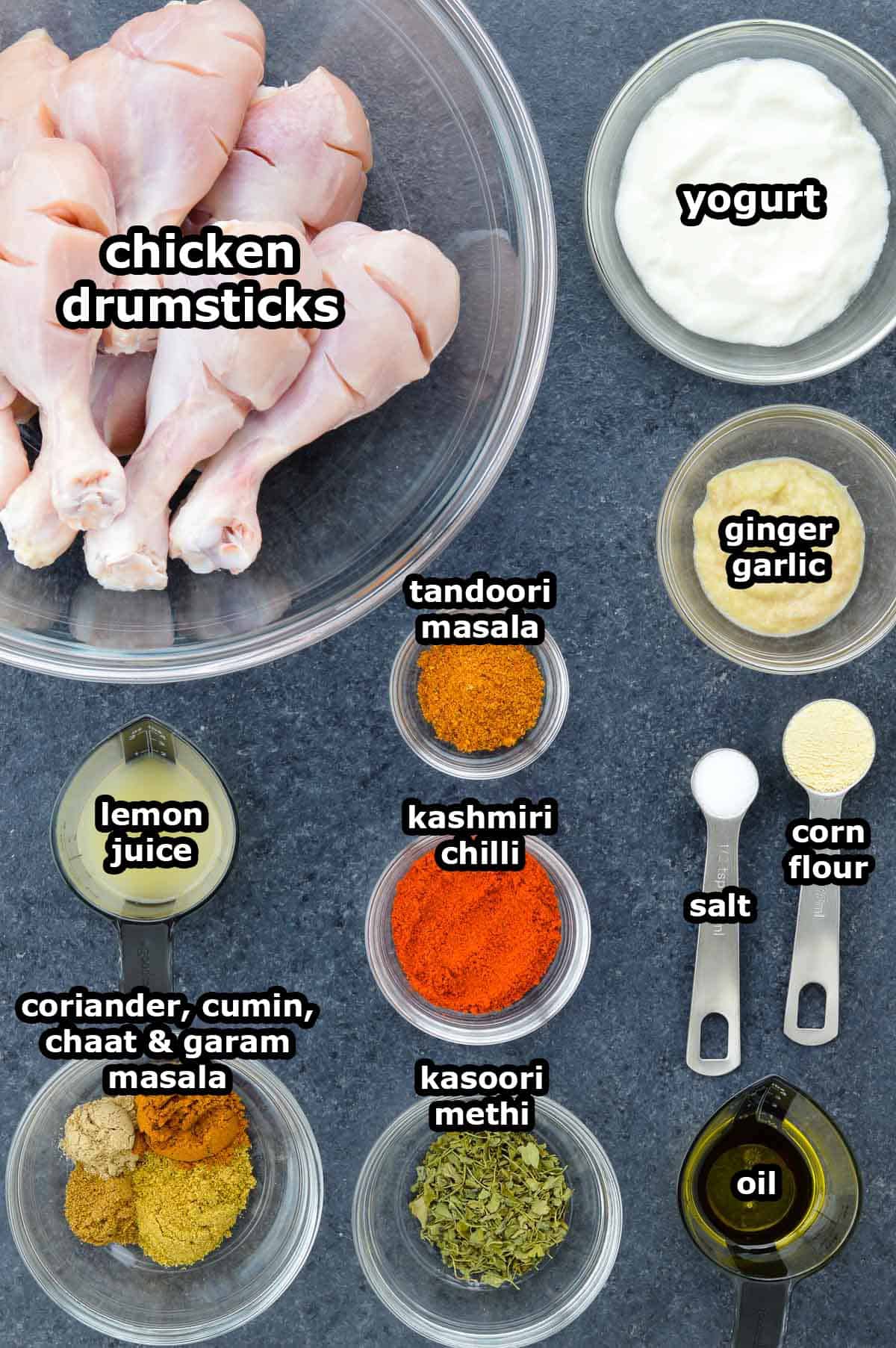 top shot of all the ingredients required to make tandoori chicken drumsticks, shared along with ingredient labels.