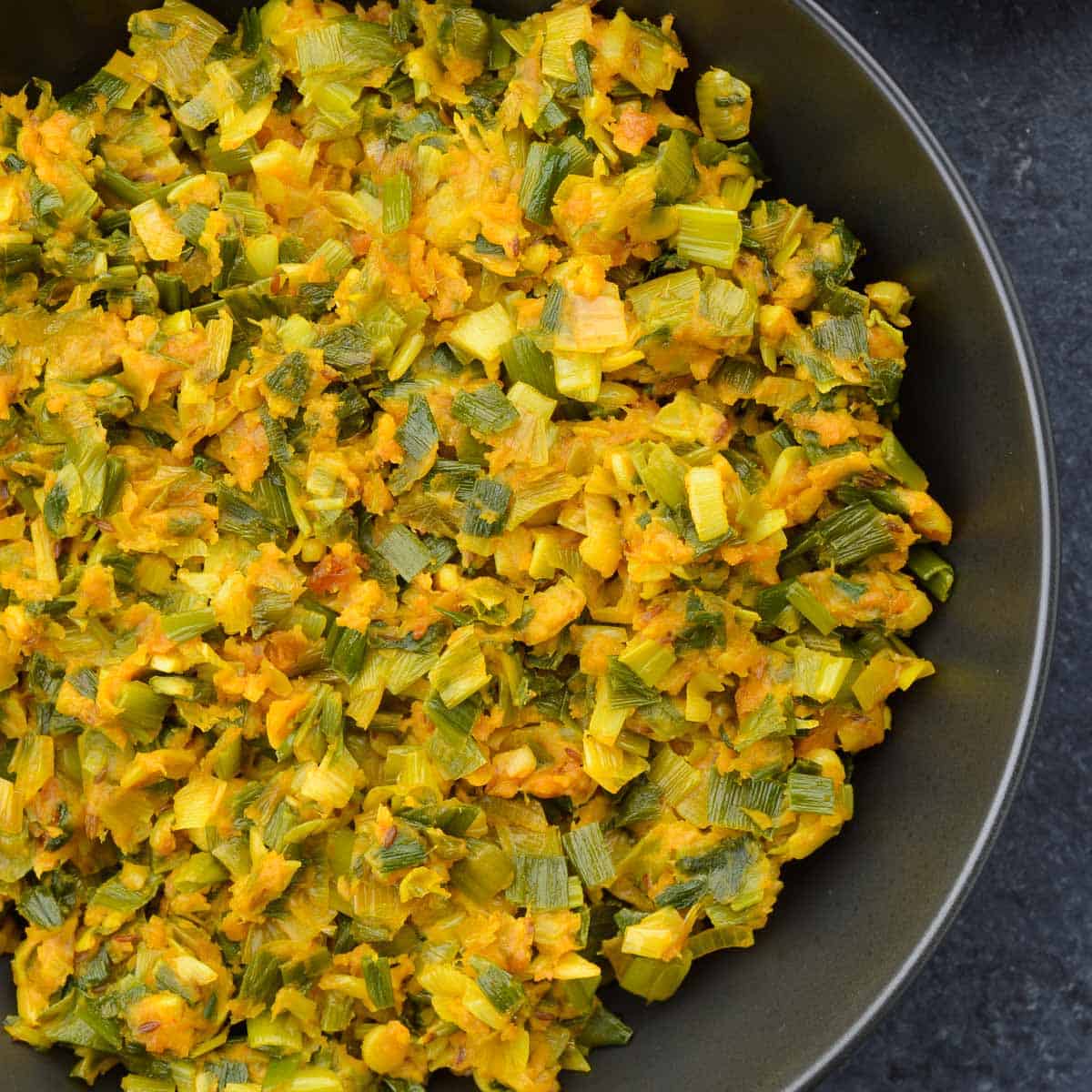 a big serving bowl of spring onion sabzi.