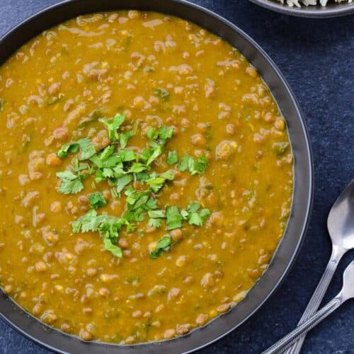 close up shot of whole masoor dal tadka in a big bowl.