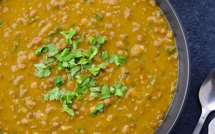 close up shot of whole masoor dal tadka in a big bowl.