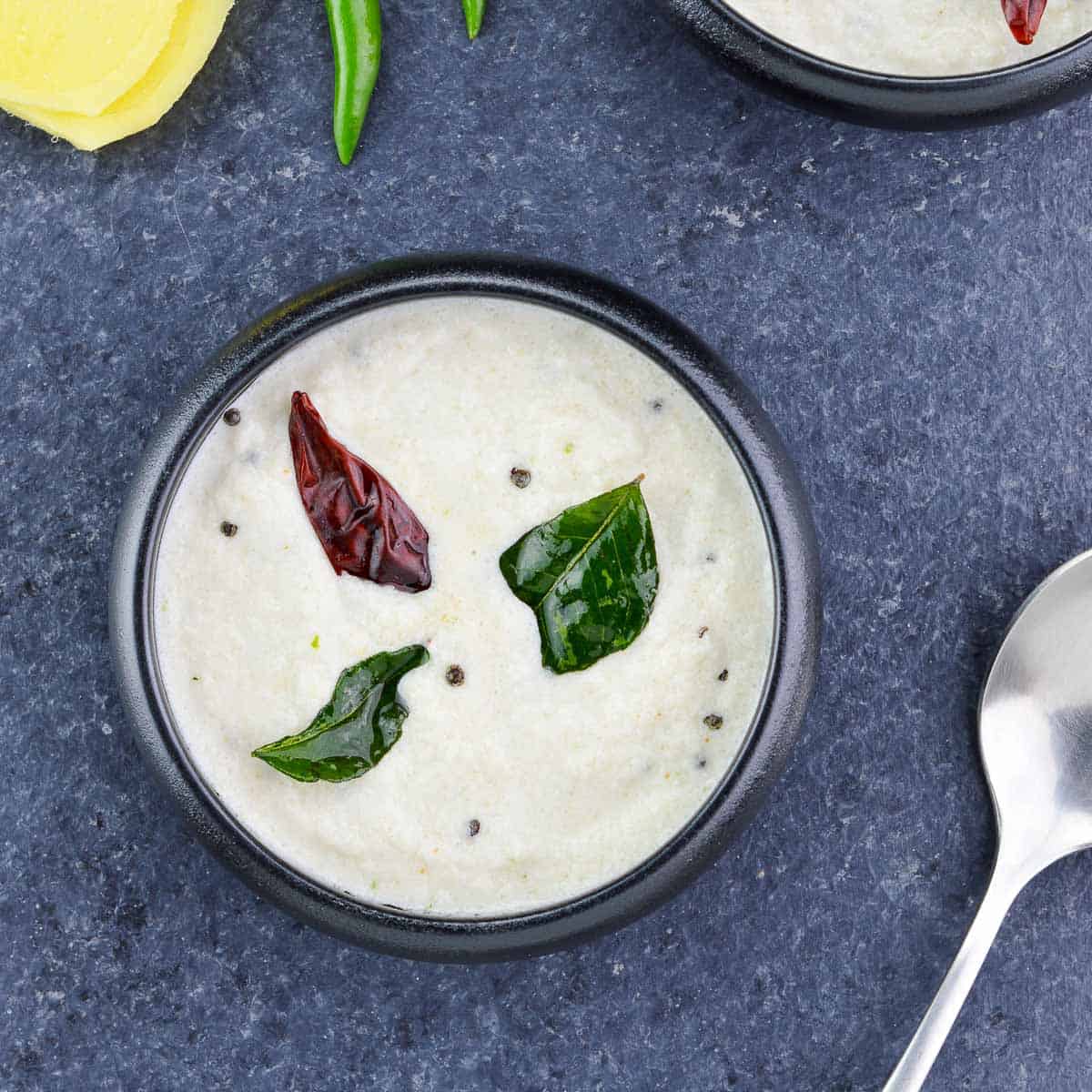 a bowl of white coconut chutney.