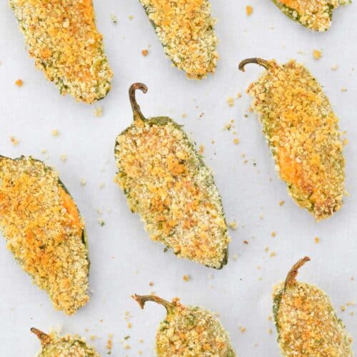 air fryer jalapeno poppers laid out on white parchment paper.