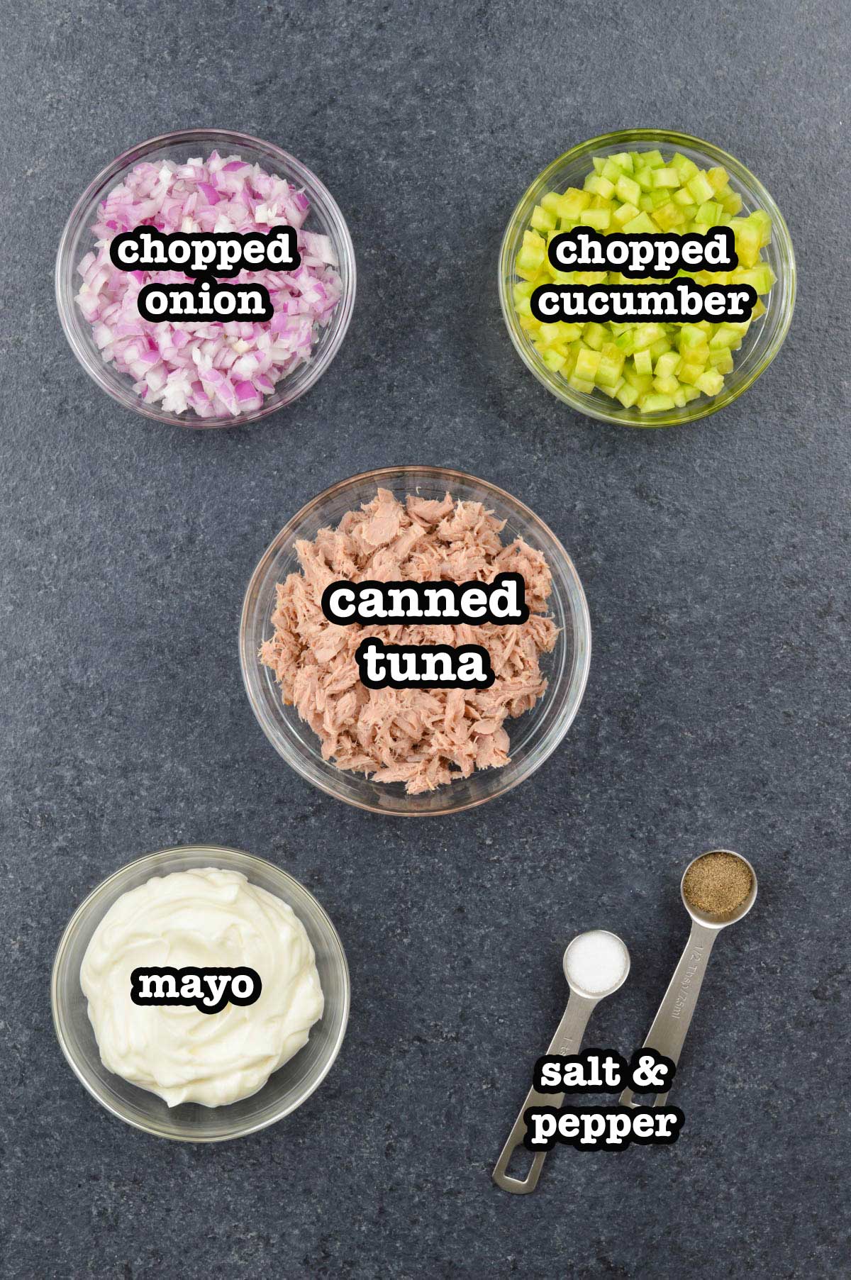top shot of all the ingredients required to make tuna salad sandwich, shared with ingredient labels.